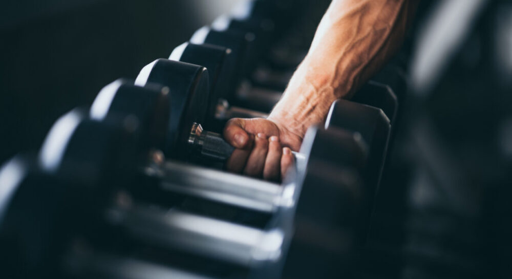 Rows of dumbbells in the gym with hand